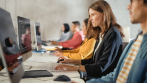 a group of students working together in a computer lab